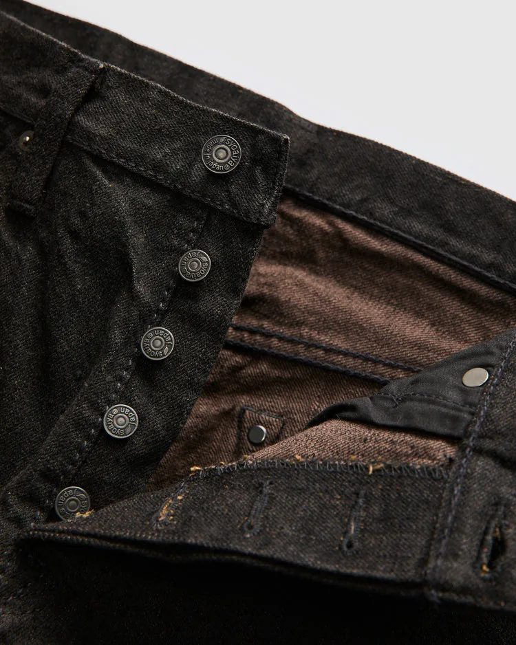 Close-up of Teacore denim fabric showing dark warp threads over a brown weft.