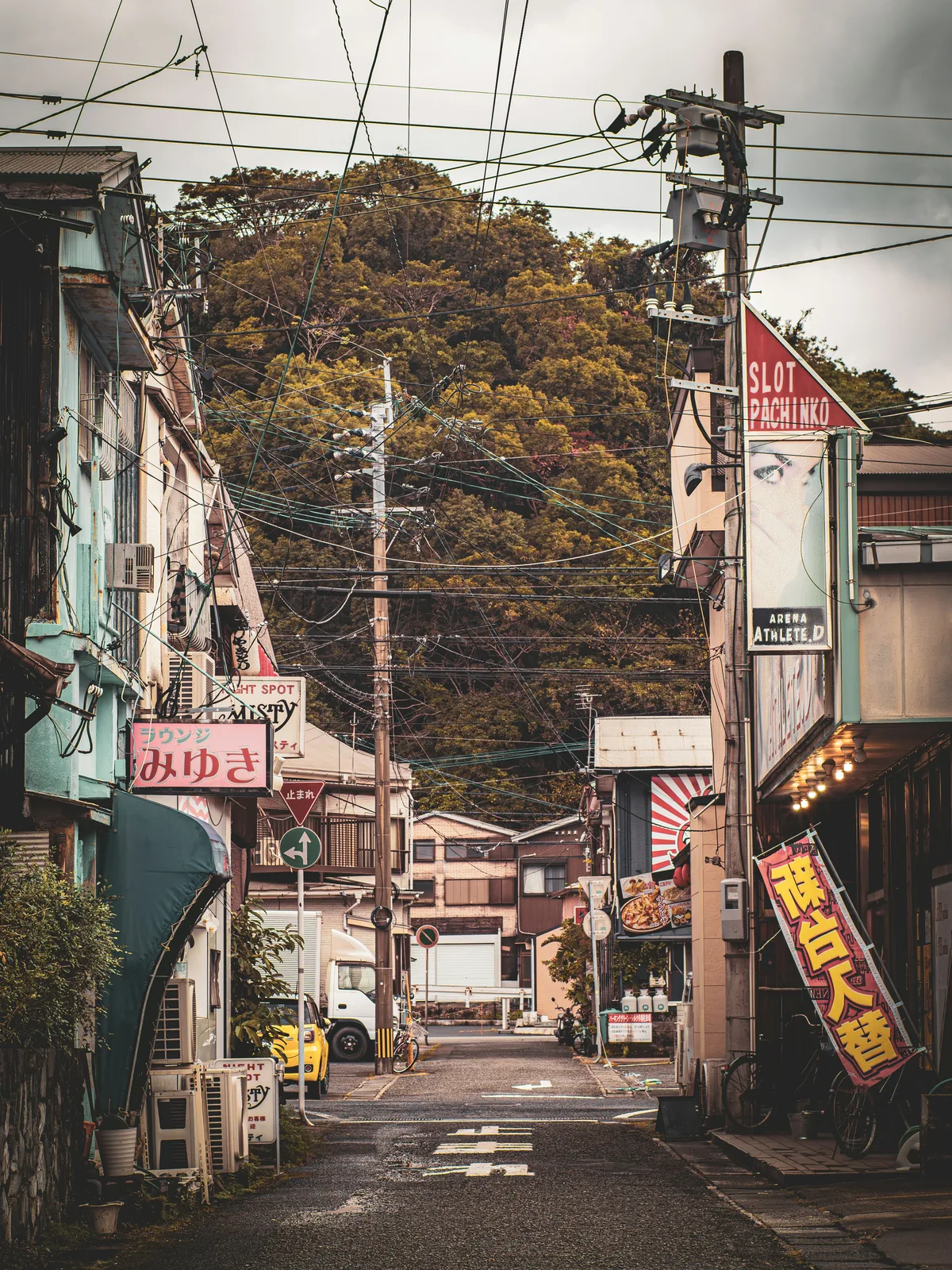 A narrow backstreet on Amami &Omacr;shima, lined with weathered buildings