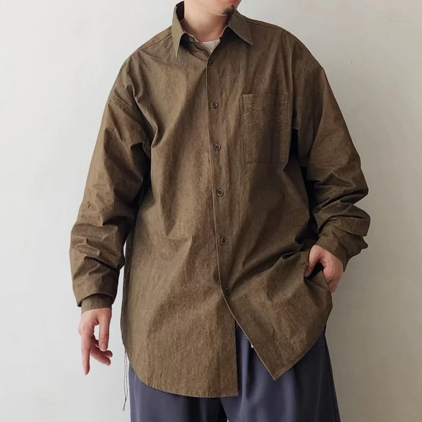 An oversized olive-brown walnut-dyed overshirt with a single patch chest pocket