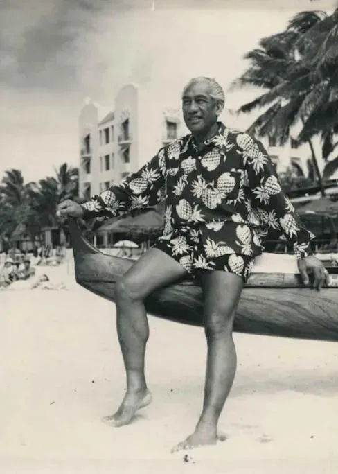 Duke Kahanamoku wearing an aloha shirt on the beach