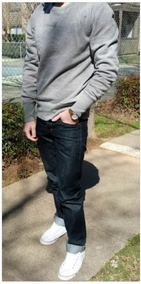 A cropped, faceless outfit photo submitted to the r/malefashionadvice WAYWT thread in 2013 — grey crewneck sweatshirt, raw denim jeans cuffed at the ankle, and white sneakers.